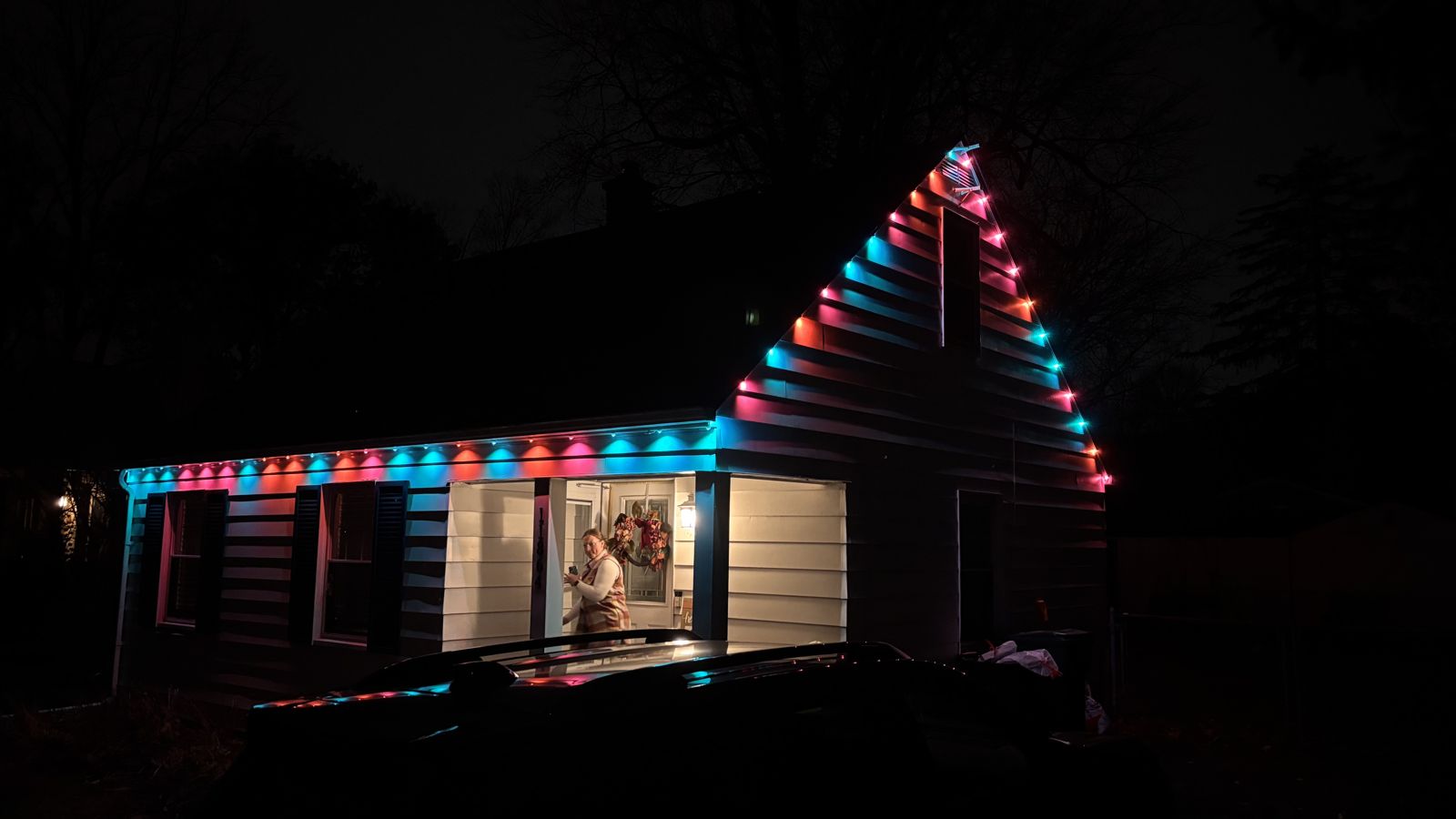 House lit in red and teal