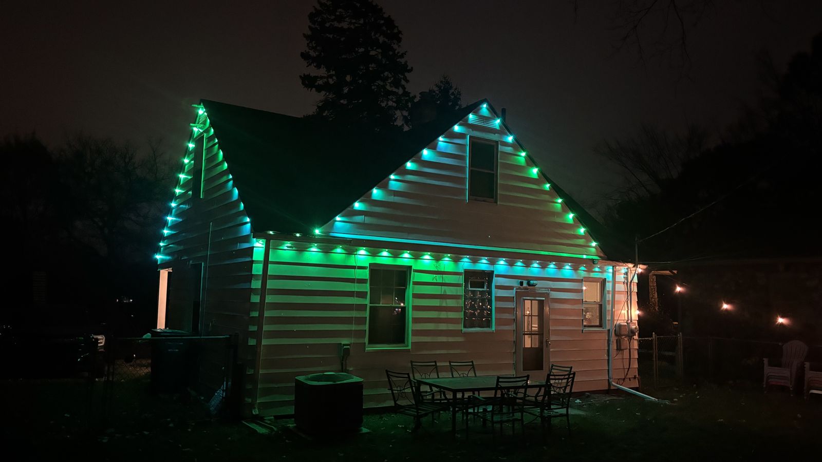 Same house lit in green